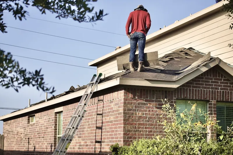 Professional roofer working on a residential roof in Treyburn